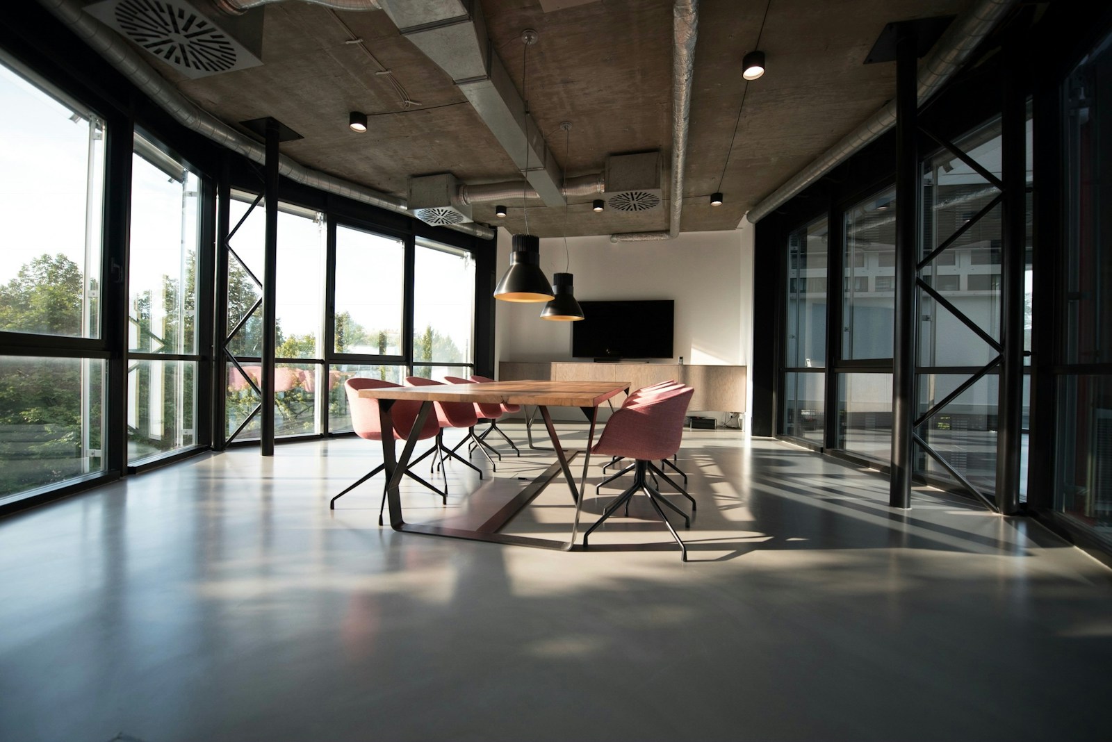 Corridor with high windows leading toward the studio bay